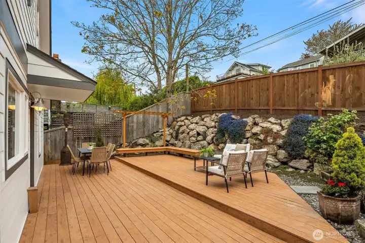 Low maintenance yard with covered BBQ area, room for seating and entertaining, and alley access to extra parking