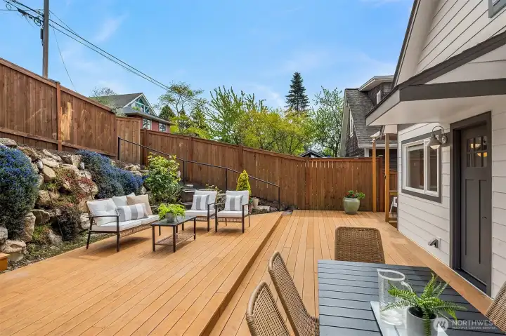 Low maintenance yard with covered BBQ area, room for seating and entertaining, and alley access to extra parking