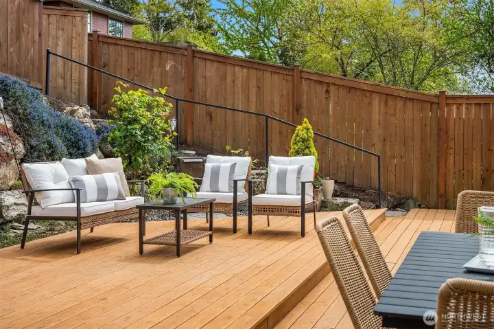 Low maintenance yard with covered BBQ area, room for seating and entertaining, and alley access to extra parking