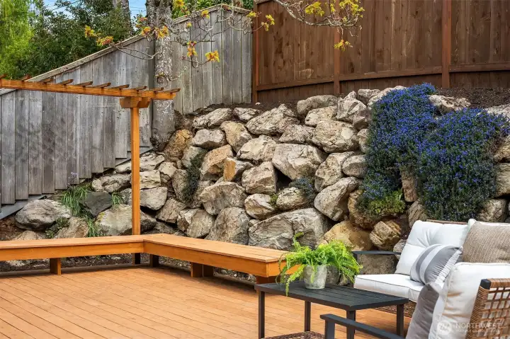 Low maintenance yard with covered BBQ area, room for seating and entertaining, and alley access to extra parking