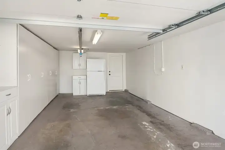 Generous garage with new garage door and great storage