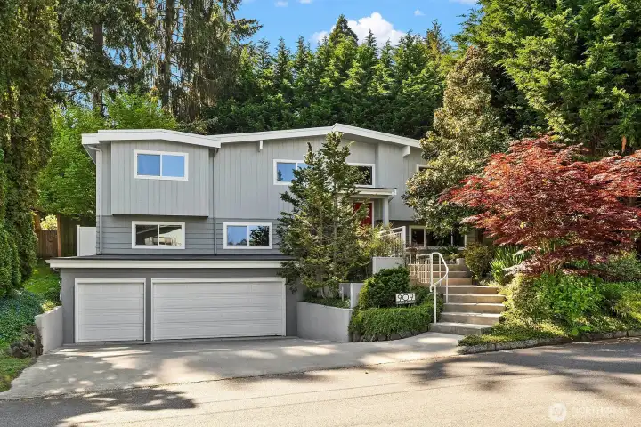 This immaculate turn-key home in the coveted Surrey Downs community impresses from the street with its striking modern facade, mature landscaping, and spacious two-car garage, perfectly positioned just blocks from downtown Bellevue.