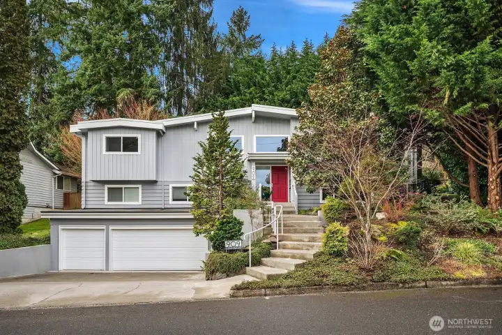 Nestled among towering mature trees, this immaculate Surrey Downs home impresses with a welcoming red front door, fresh landscaping, and a spacious three-car garage, the perfect blend of charm and functionality in an unbeatable Bellevue location.