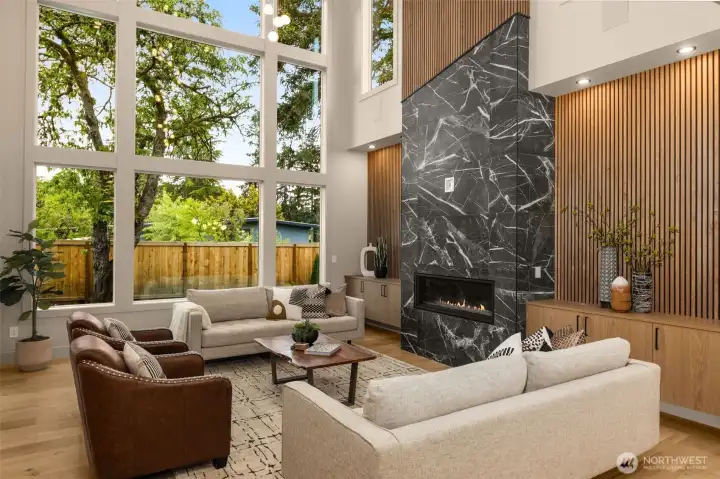 Two story great room with full window wall and an abundance of natural light