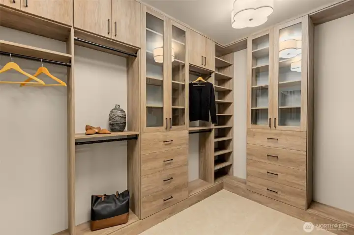 Primary suite closet with custom built ins