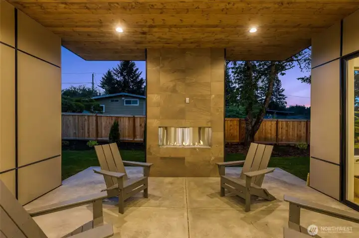Covered outdoor living with gas fireplace, built in speakers and pre-wiring for electric heaters