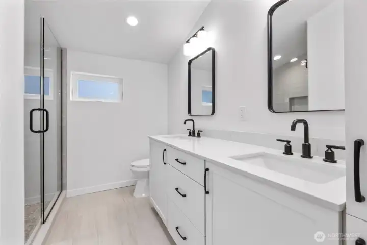 Primary bath with dual vanities and linen cabinet representative photo Primary bath with dual vanities and linen cabinet representative photo