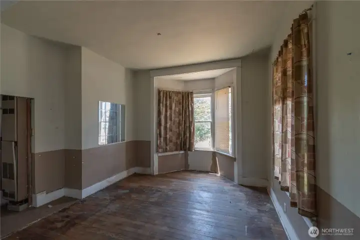 Interior living room of classic Victorian built 1900-Home is in need of complete renovation, or a tear down and rebuilt on same lot Interior living room of classic Victorian built 1900-Home is in need of complete renovation, or a tear down and rebuilt on same lot