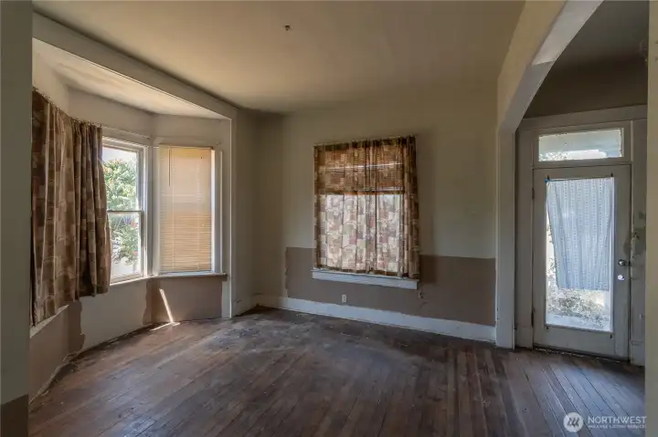 Another view of the living area with glass front door. Stairs that go upstairs are very steep. Another view of the living area with glass front door. Stairs that go upstairs are very steep.