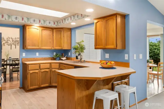 Bright and inviting kitchen is literally at the center and heart of this home! Bar counter provides connection to living space, skylight offers fabulous natural light, and LVP floors are attractive and forgiving.