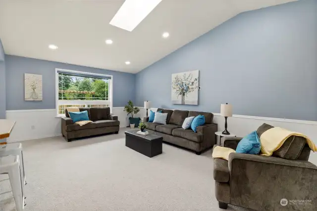 Wainscoting and recessed lighting add to the delight in this spacious family room, aka gathering spot.  :)