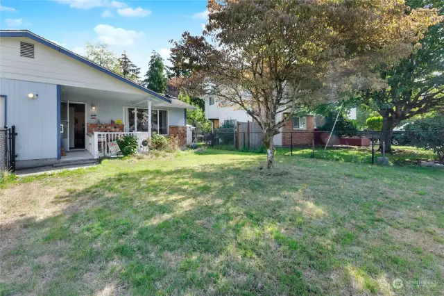 Fully fenced front yard with front porch