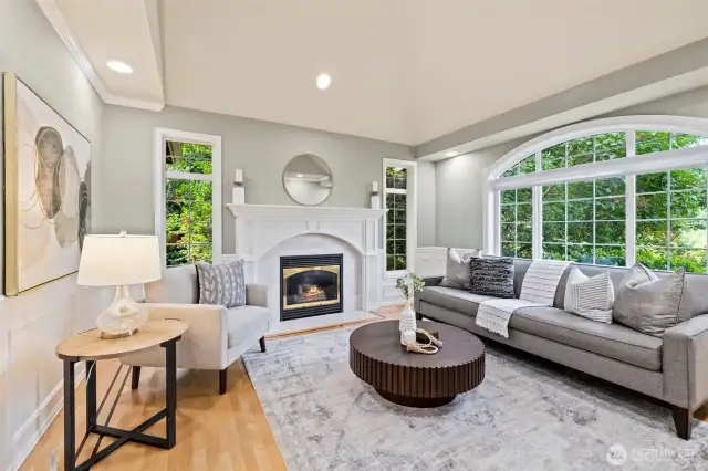 Formal living room off the foyer with gas fireplace and hardwood floors.
