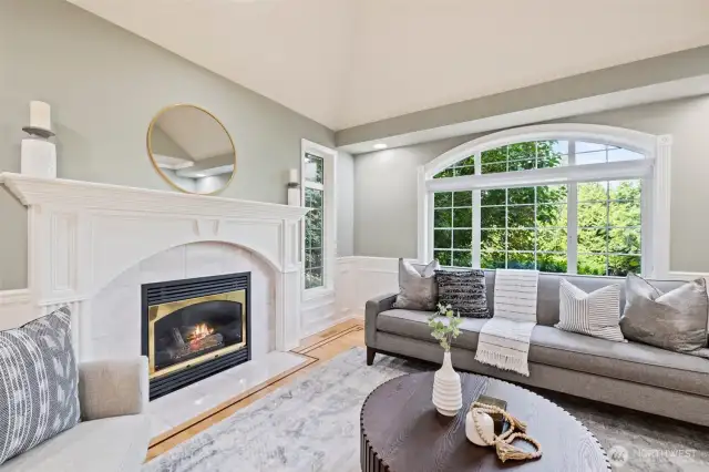 Formal living room off the foyer with gas fireplace and hardwood floors.