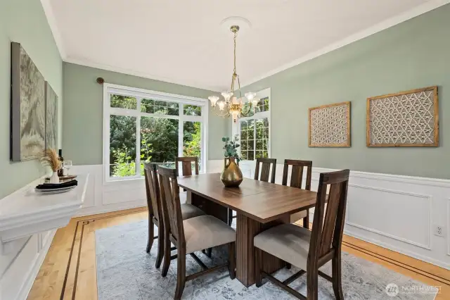 Formal dining room with hardwood floors can easily accommodate a larger table.
