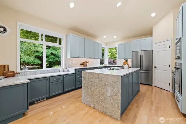 Beautifully remodeled kitchen with walk-in pantry, quartz countertops, plenty of cabinetry, stainless appliances and hardwood floors.  This is a one story rambler; so you could add a hood vent over the range quite easily if desired.