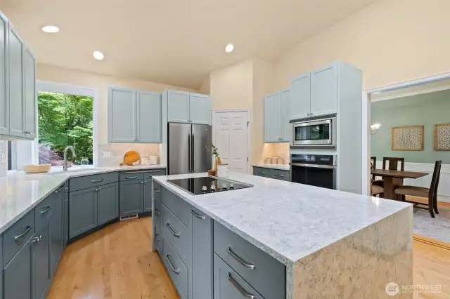 Beautifully remodeled kitchen with walk-in pantry, quartz countertops, plenty of cabinetry, stainless appliances and hardwood floors.  This is a one story rambler; so you could add a hood vent over the range quite easily if desired.