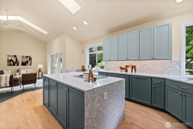 Remodeled kitchen with vaulted ceilings flows seamlessly into the family room.