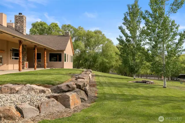 Welcome to this 7.5-acre luxury retreat just outside city limits. This custom one-level home offers 5,306 sq ft of thoughtfully designed space with a grand entry, 10' ceilings, and multiple fireplaces. The chef’s kitchen features Corian counters, a Wolf range, double ovens, and premium cabinetry. The spacious primary wing includes a sitting area, dual bathrooms, soaking tub, and French doors to the patio. A stunning great room with corner windows frames views of the Columbia River. Juniper logs accent both porches. A 3-car attached garage and 3,000 sq ft shop with bath add versatility. The property is fully fenced, irrigated with in-ground sprinklers, and includes outbuildings, RV hookups, and power throughout. Subdividable—buyer to do due diligence.