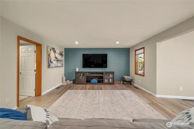 The family room leads to the laundry room and 1/2 bath to the left and the kitchen to the right