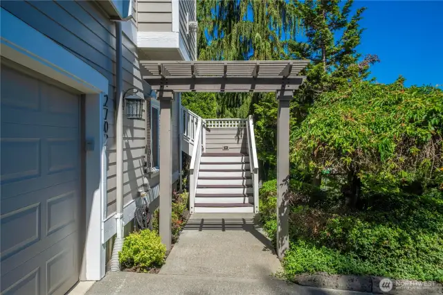 The main entrance is straight ahead up these stairs. Residents enter easily through the 3 car garage to the finished lower level. A level entrance is also available at the upper driveway.