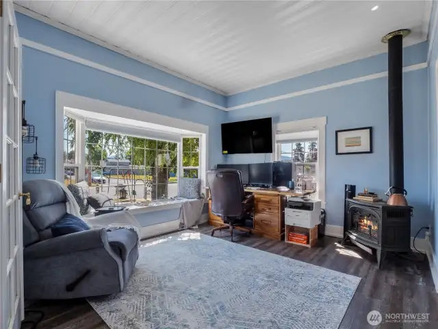 Imagine getting cozy in this den/office space. From the bay window is a peak-a-boo view of Mt. Rainier. Close the French doors and this space becomes part of the primary bedroom suite.