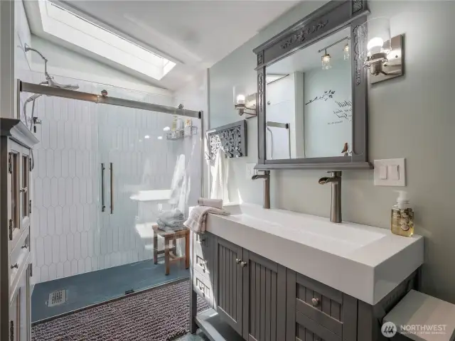 Walk-in shower with a skylight providing great natural light.