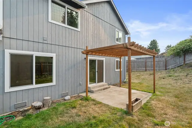 Backyard wit patio space and pergola