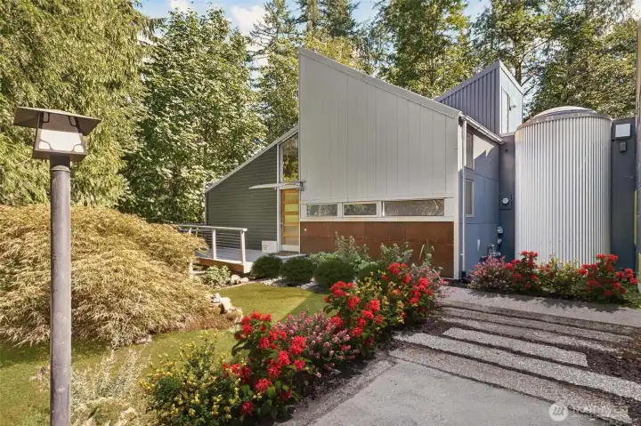 The thoughtful design for this unique home involves curved walls and a unique cylindrical connector at the heart of the home, lending a subtle “ship-like” feel to the architecture and flow of the interior. Most of the siding is new, and was selected to reflect the modern, sparse feel to the outside of the property.