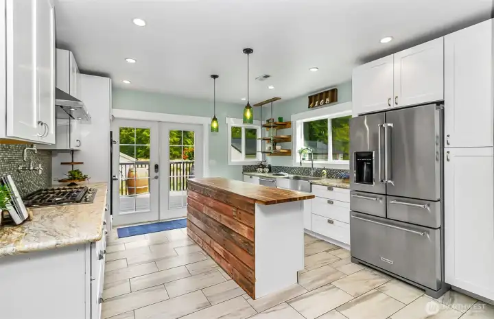 An amazing, updated kitchen.  Tons of cabinets & storage, like new appliances, butcher block island & french doors to the back deck.