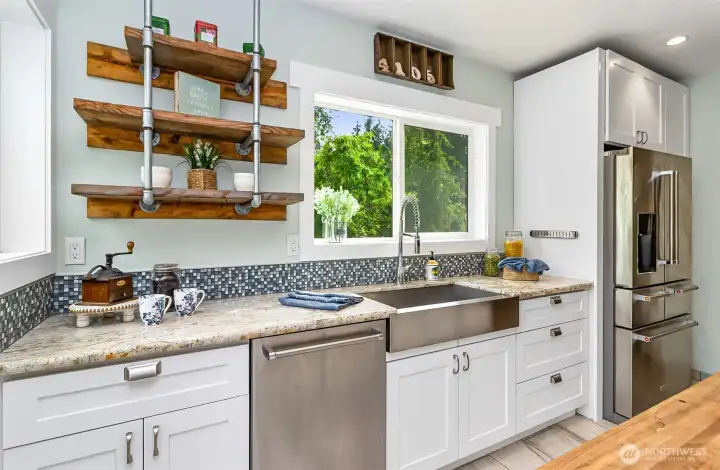 Stainless steel farm sink & open wood shelving.  So much room in this kitchen!