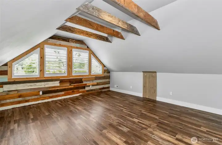 Primary bedroom is on the second level.  Wood beams and plantation shutters bring this room alive.