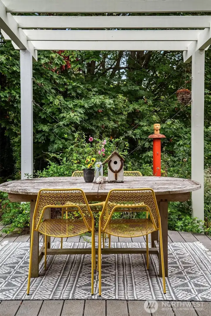 Just the right amount of lawn, a Parisian style gravel seating area and a deck made for entertaining.