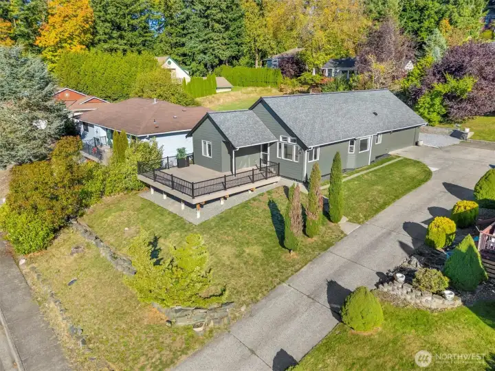Aerial view highlighting the landscaped yard and surrounding neighborhood.