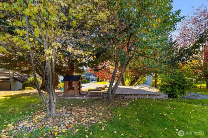 Shaded backyard retreat surrounded by trees for privacy.