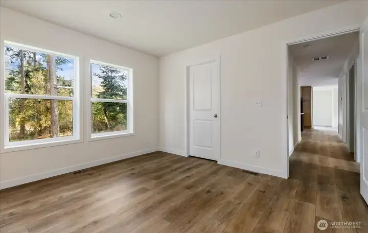 Primary Bedroom with windows facing back yard
