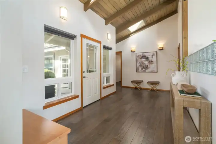 Entering this lovely home you are greeted with beautiful vaulted wood ceilings....There is a powder bath in the back on the right, and down the hall is a den with 3/4 bath and then the door to the Natatorium. Entering this lovely home you are greeted with beautiful vaulted wood ceilings....There is a powder bath in the back on the right, and down the hall is a den with 3/4 bath and then the door to the Natatorium.