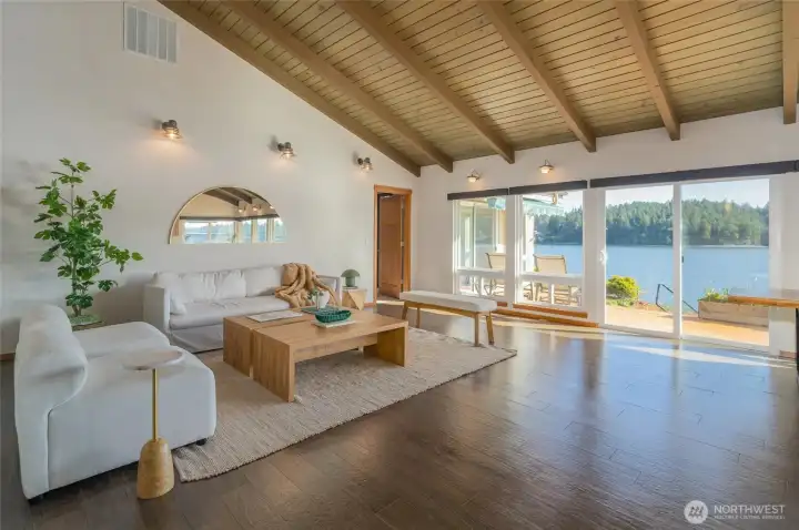 The main living space is gracious and full of light...offering wonderful views from the floor to ceiling windows with two sliding glass doors to access the large wrapped deck... The main living space is gracious and full of light...offering wonderful views from the floor to ceiling windows with two sliding glass doors to access the large wrapped deck...