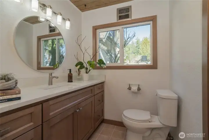 The 2nd primary bath has a tiled tub shower and new cabinetry.