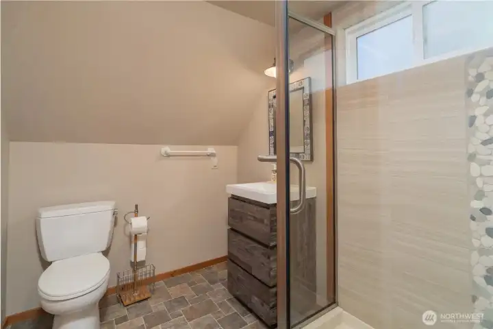 The upstairs 3/4 bath with glass shower and walk-in closet to the far right. The upstairs 3/4 bath with glass shower and walk-in closet to the far right.