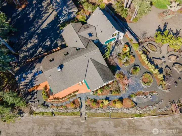 Lush landscaping and grounds surround this beautiful home. The terrace and bulkhead frame the space.