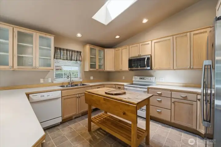 Movable kitchen island is included with sale. Skylight in kitchen for lots of light.