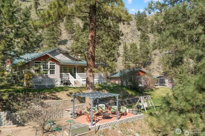 Home, pergola, and garage in background.