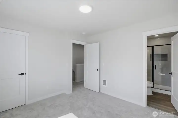 Spacious primary suite with clean finishes and ample closet space