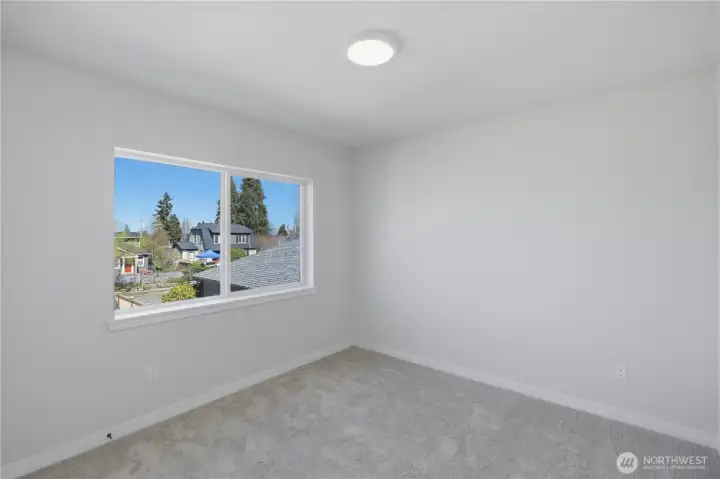 Upstairs bedroom with natural light and versatile use