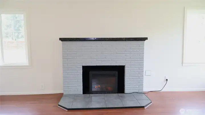 Electric insert within the fireplace is perfect for a relaxing evening.