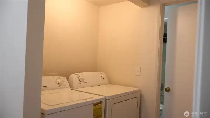 Laundry area is located in the hallway for ease of access.