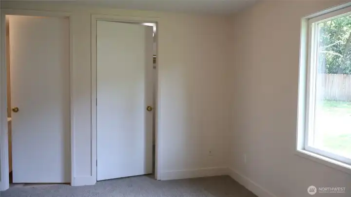 Primary bedroom with walk-in closet and personal half bath.