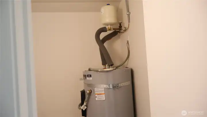 Brand new hot water heater with expansion tank.