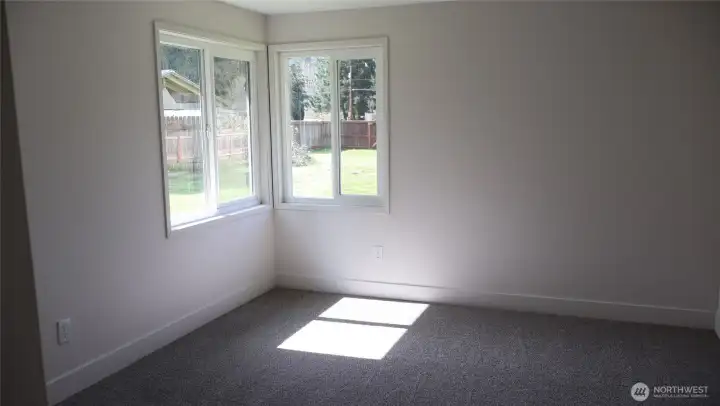 Second bedroom with new carpeting and paint. Look at how much light flows through to warm the room.